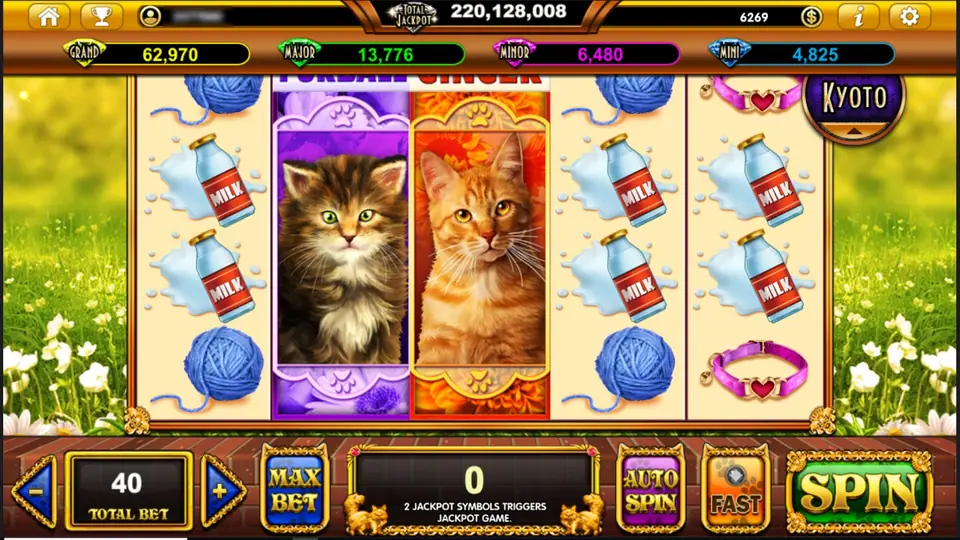 Two tall kitten panels on reels 2 and 3, Furball in purple and Ginger in orange, with milk bottles, yarn and a pink collar on the other reels, the jackpot bar above and TOTAL BET 40